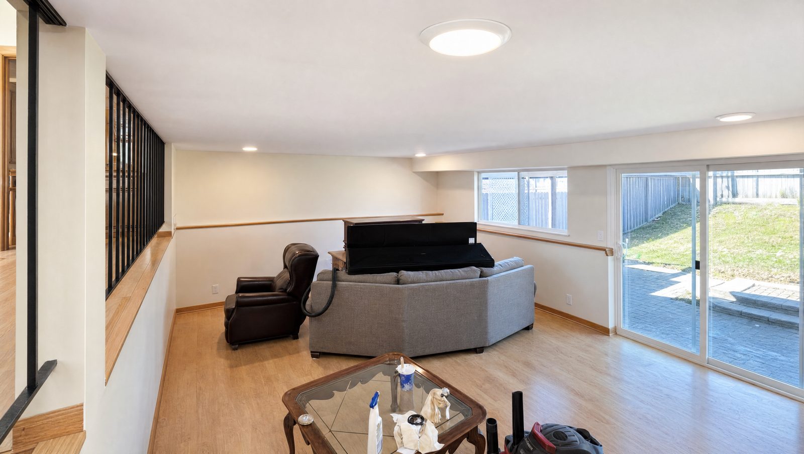 Finished basement family room with new lighting and flooring