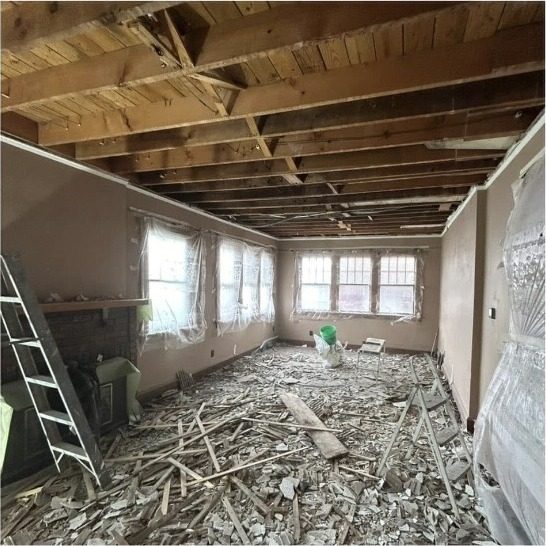 Living room before: ceiling torn out to the joists