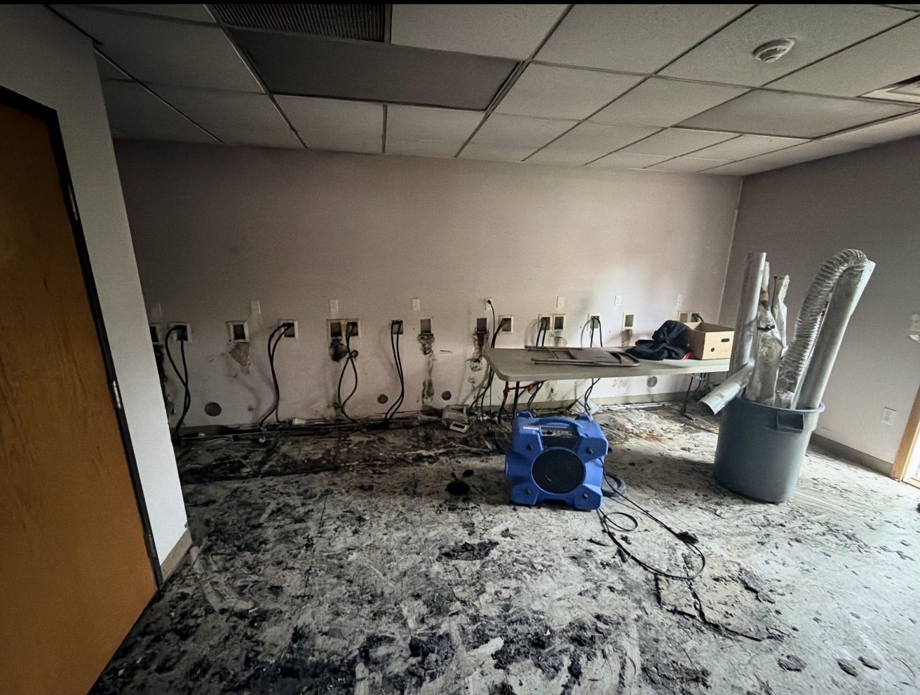 Office before: fire-damaged walls and floor
